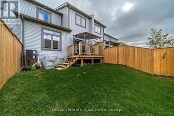Prince Edward County (Picton Ward) townhouse for rent - A house with a deck and a fence in the yard.
