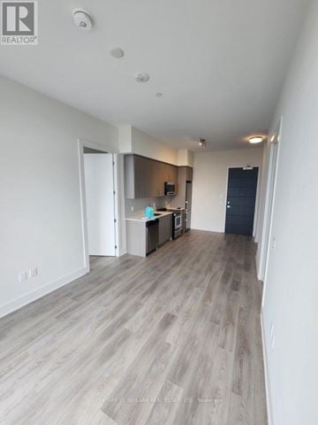 Hamilton (Beasley) condo for rent - A spacious room with a kitchenette and a bar area.