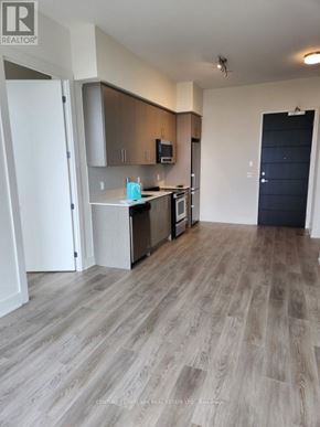 Hamilton (Beasley) condo for rent - A kitchen with a refrigerator, microwave, and oven.
