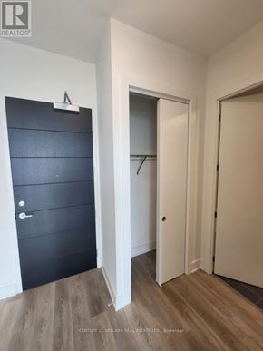 Hamilton (Beasley) condo for rent - A hallway with a black door on the left and two white doors on the right.
