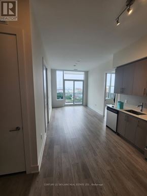 Hamilton (Beasley) condo for rent - A real estate listing photo of a kitchen and living room.