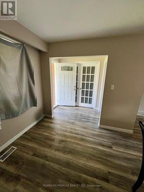 Welland (N. Welland) apartment for rent - A room with a white door and wooden flooring.