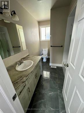 Welland (N. Welland) apartment for rent - A bathroom with a marble countertop and a white sink.
