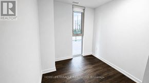 Burlington (Alton) condo for rent - A room with white walls and a wooden floor.