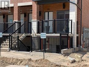 Cambridge townhouse for rent - A black metal railing with a sign that says "RESERVED PARKING" is in front of a building.