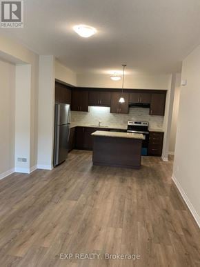 Cambridge townhouse for rent - A kitchen with wooden floors and white walls.