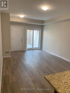 Cambridge townhouse for rent - A room with wooden flooring and a sliding glass door.