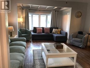 Niagara Falls (Hospital) apartment for rent - A living room with a grey couch and a white coffee table.