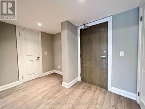 Whitchurch-Stouffville (Stouffville) condo for rent - A room with a white door and a wooden floor.