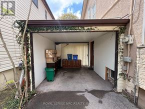 Niagara Falls (Hospital) apartment for rent - A garage with a green trash can and boxes inside.