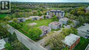 London apartment for rent - An aerial view of a residential area with apartment buildings and green lawns.