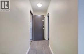London apartment for rent - A hallway with a door on the right and a light on the ceiling.