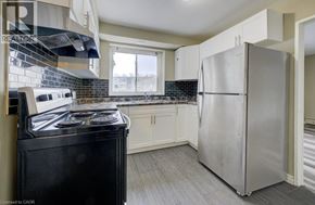 London apartment for rent - A kitchen with a black stove top oven and a silver refrigerator.