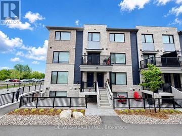 Ottawa townhouse for rent - A modern apartment building with a clear blue sky in the background.