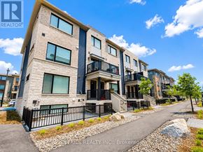 Ottawa townhouse for rent - A row of modern townhouses with balconies and a clear sky above.