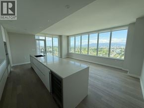 Vancouver apartment for rent - A spacious kitchen with a large island and a view of the city.