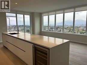 Vancouver apartment for rent - A kitchen with a large island and a view of the city.