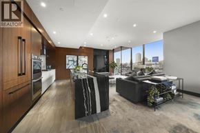 Burnaby apartment for rent - A modern kitchen with a large island and a view of the city.