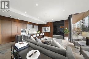 Burnaby apartment for rent - A modern living room with a grey sofa and a coffee table.