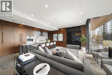 Burnaby apartment for rent - A modern living room with a grey sofa and a coffee table.