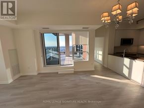 Toronto (Tam O'shanter-Sullivan) condo for rent - A spacious kitchen and living room with white walls and wooden flooring.