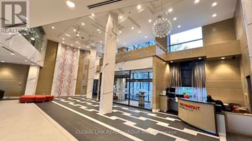 Toronto (Henry Farm) condo for rent - A spacious office lobby with a reception desk and a large chandelier.