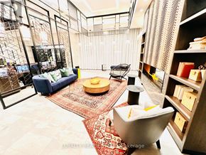 Toronto (Mimico) condo for rent - A living room with a blue sofa, a yellow bowl, and a red rug.