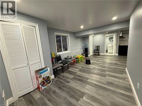 Kitchener apartment for rent - A room with a grey floor and a white door.