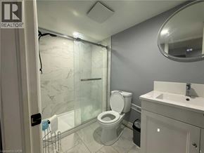 Kitchener apartment for rent - A bathroom with a toilet, sink, and shower.
