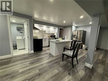 Kitchener apartment for rent - A kitchen with a black chair in the middle of the room.