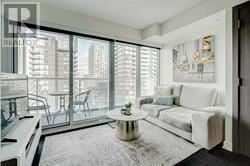 Toronto (Waterfront Communities) condo for rent - A living room with a white couch and a coffee table.