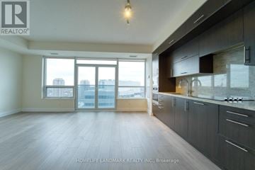 Toronto (Willowdale East) condo for rent - A spacious kitchen with dark wood cabinets and a large window overlooking the city.