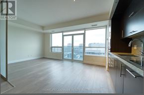 Toronto (Willowdale East) condo for rent - A spacious living room with a kitchen area to the right.