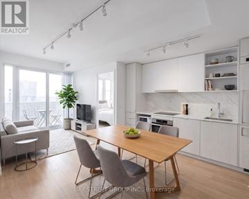 Toronto (Waterfront Communities) condo for rent - A modern kitchen with a dining table and chairs.