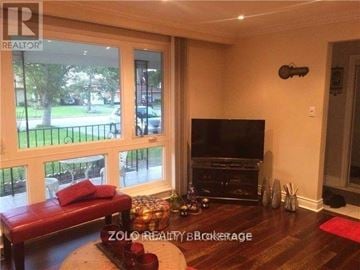 Toronto (Thistletown-Beaumonde Heights) apartment for rent - A living room with a red couch and a television.