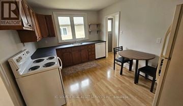 Ottawa apartment for rent - A kitchen with a stove, table and chairs.