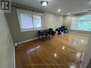 Waterloo apartment for rent - A room with wooden flooring and a table with chairs.