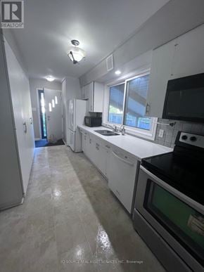 Waterloo apartment for rent - A well-lit, clean kitchen with white appliances and cabinets.