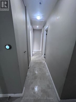 Waterloo apartment for rent - A long hallway with a green light on the wall.