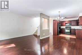 Waterloo townhouse for rent - A well-lit, spacious kitchen and living room with hardwood floors.