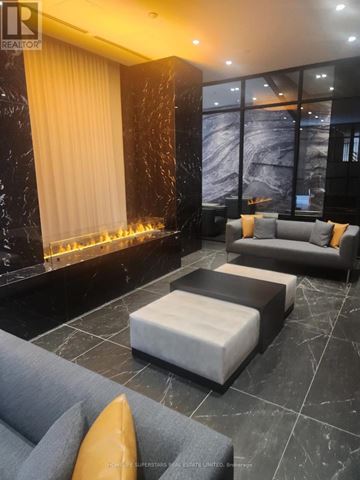 Toronto (Church-Yonge Corridor) condo for rent - A living room with a grey sofa and a fireplace.