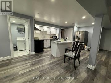Kitchener apartment for rent - A kitchen with a black chair in the middle of the room.
