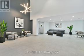 Ottawa apartment for rent - A modern living room with a grey couch and a white chair.