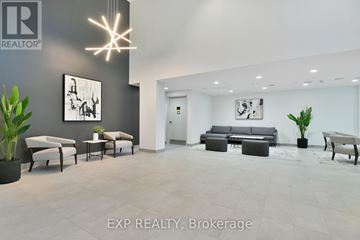 Ottawa apartment for rent - A modern living room with a grey couch and a white chair.