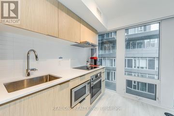 Toronto (Church-Yonge Corridor) condo for rent - A modern kitchen with wooden cabinets and stainless steel appliances.