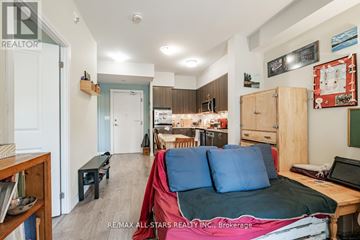Toronto (Bathurst Manor) condo for rent - A living room with a couch and a laptop on a table.