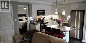 Kitchener condo for rent - A modern kitchen with a dining table and chairs.