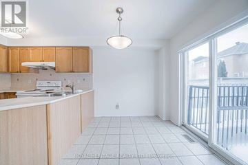 Markham (Berczy) apartment for rent - A kitchen with wooden cabinets and a white countertop.