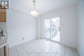 Markham (Berczy) apartment for rent - A white tiled room with a sliding glass door leading to a balcony.
