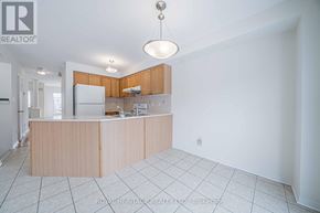 Markham (Berczy) apartment for rent - A kitchen with white cabinets and a wooden island.